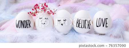 Minimal easter concept. Easter eggs with painted smiley faces and bird feather on pastel background. Wedding couple eggs. Married. Valentines day Minimal easter concept. Easter eggs with painted smiley faces and bird feather on pastel background. Wedding couple eggs. Married. Valentines day 76357090