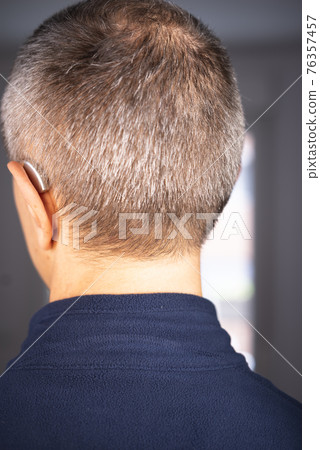 Hearing aid ear of man Hearing aid ear of man 76357457