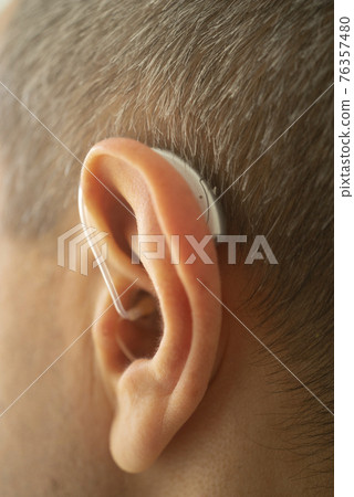 Hearing aid ear of man Hearing aid ear of man 76357480