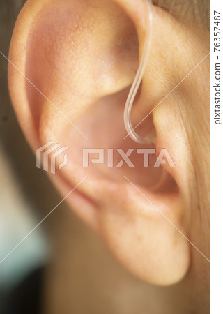 Hearing aid ear of man Hearing aid ear of man 76357487
