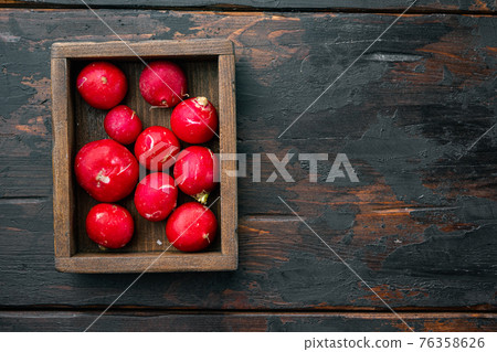 Summer harvested red radish. Growing organic vegetables, in wooden box, on old dark wooden table background, top view flat lay , with copyspace and space for text 76358626
