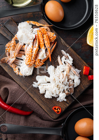 Ingredients for breakfast omelette with crab meat and cheese, on dark wooden background, top view flat lay Ingredients for breakfast omelette with crab meat and cheese, on dark wooden background, top view flat lay 76358628
