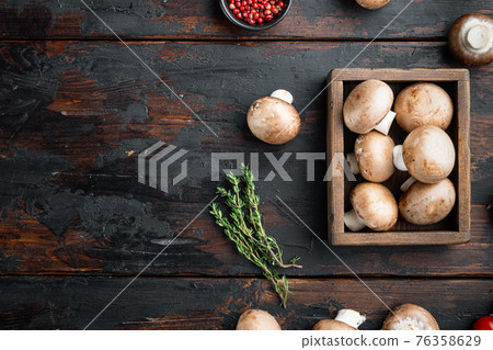 Raw mushrooms champignons, on old dark wooden table background, top view flat lay , with space for text copyspace Raw mushrooms champignons, on old dark wooden table background, top view flat lay , with space for text copyspace 76358629