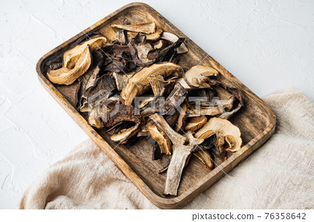 Dried porcini mushrooms, on white background 76358642
