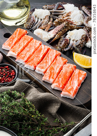 Fresh Crab meat surimi with blue swimming crab, on dark wooden background 76358643