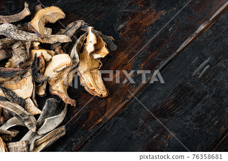 Dried porcini mushrooms, on old dark wooden table background, top view flat lay , with space for text copyspace 76358681