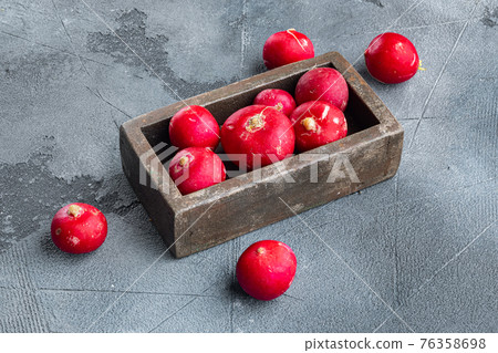 Summer harvested red radish. Growing organic vegetables, in wooden box, on gray background 76358698