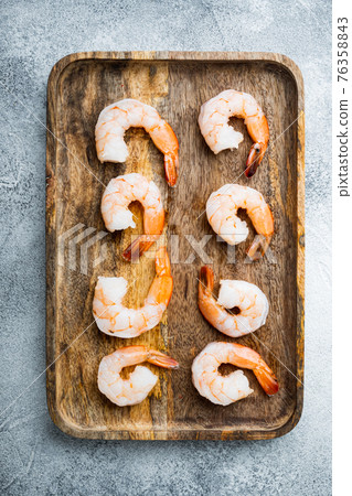 Peeled Shrimps, Prawns, on wooden tray, on gray background, top view flat lay Peeled Shrimps, Prawns, on wooden tray, on gray background, top view flat lay 76358843