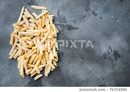 Frozen French fries potatoes, on gray background, top view flat lay , with copyspace and space for text Frozen French fries potatoes, on gray background, top view flat lay , with copyspace and space for text 76358986
