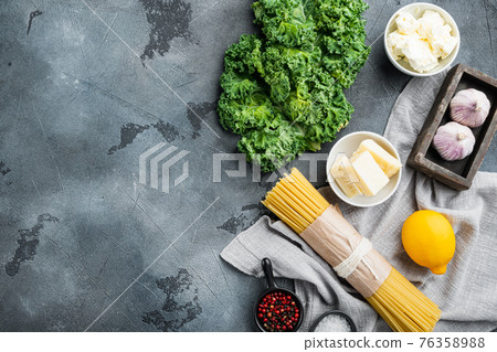 Ingredients for making pasta. Raw spaghetti, on gray background, top view flat lay , with copyspace and space for text Ingredients for making pasta. Raw spaghetti, on gray background, top view flat lay , with copyspace and space for text 76358988