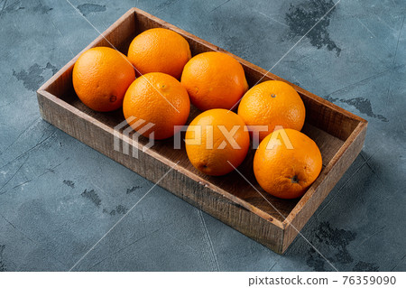 Raw Organic Cara Navel Oranges, in wooden box, on gray stone background , with copyspace and space for text 76359090