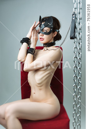 Nude woman in topless cat mask in leather straps bdsm 76361958