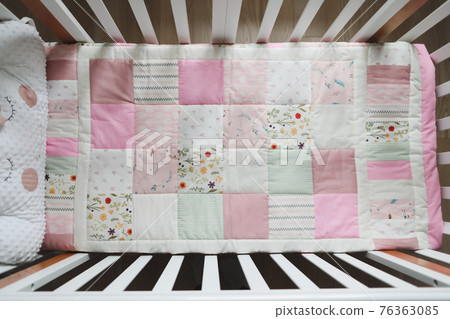 Cozy baby cot with pink patchwork blanket. Baby bedding. Bedding and textile for nursery. Nap and sleep time Cozy baby cot with pink patchwork blanket. Baby bedding. Bedding and textile for nursery. Nap and sleep time 76363085