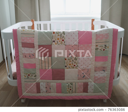Cozy baby cot with pink patchwork blanket. Baby bedding. Bedding and textile for nursery. Nap and sleep time Cozy baby cot with pink patchwork blanket. Baby bedding. Bedding and textile for nursery. Nap and sleep time 76363086