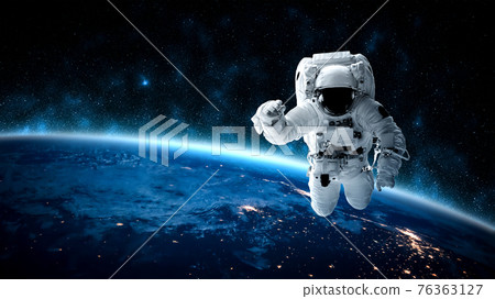 Astronaut spaceman do spacewalk while working for space station 76363127
