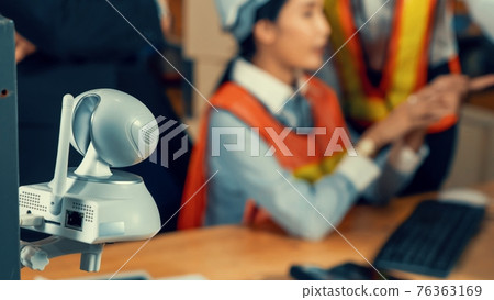Security camera watching warehouse workers working in the storehouse Security camera watching warehouse workers working in the storehouse 76363169
