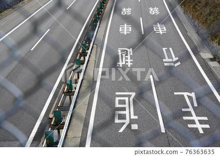 Scenery with overtaking lanes, driving lanes and road markings on the road surface Scenery with overtaking lanes, driving lanes and road markings on the road surface 76363635