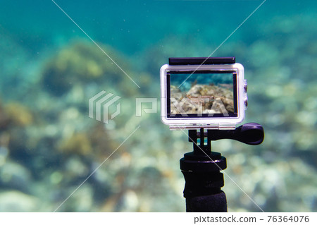 Using action-camera in waterproof box to make photos and video underwater 76364076