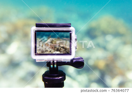 Using action-camera in waterproof box to make photos and video underwater 76364077