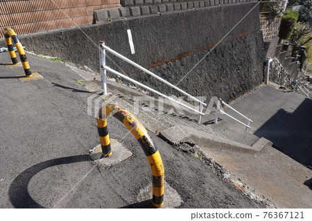 Concrete stairs and bollard fences in a sloping residential area of Yokohama 76367121