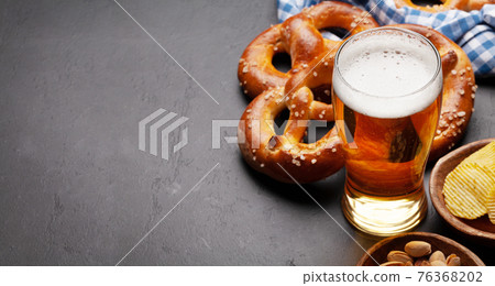 Lager beer, nuts, potato chips and fresh homemade pretzel 76368202