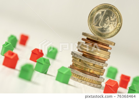 Coin stack with many house plastic models 76368464