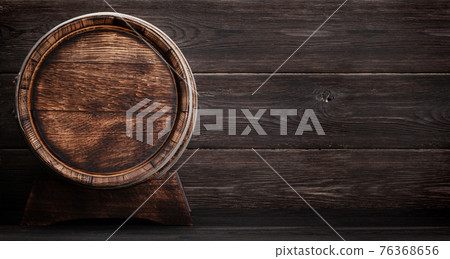 Mug of light lager beer and old wooden barrel 76368656