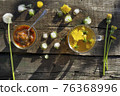 Medicinal Tea from dandelion in  glass cup, honey dandelion  on wooden rustic  table 76368996