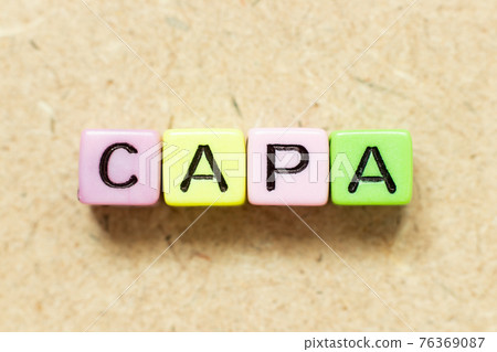 Color alphabet letter block in word CAPA (abbreviation of corrective action and preventive action) on wood background 76369087
