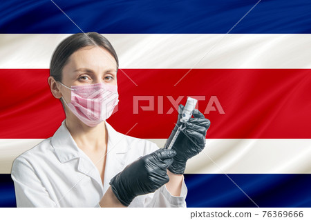Girl doctor prepares vaccination against the background of the Costa Rica flag. Vaccination concept Costa Rica Girl doctor prepares vaccination against the background of the Costa Rica flag. Vaccination concept Costa Rica 76369666
