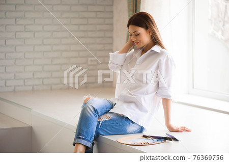 Concept Artist Beautiful girl. Beautiful women are creating art. Young artist painting in the house. 76369756