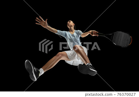 Female professional tennis player in action, motion isolated on black background, look from the bottom. Concept of sport, movement, energy and dynamic. 76370027