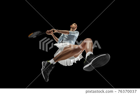 Female professional tennis player in action, motion isolated on black background, look from the bottom. Concept of sport, movement, energy and dynamic. Female professional tennis player in action, motion isolated on black background, look from the bottom. Concept of sport, movement, energy and dynamic. 76370037