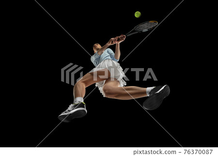Female professional tennis player in action, motion isolated on black background, look from the bottom. Concept of sport, movement, energy and dynamic. Female professional tennis player in action, motion isolated on black background, look from the bottom. Concept of sport, movement, energy and dynamic. 76370087