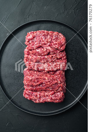 Mince. Ground meat with ingredients for cooking, on black background, top view flat lay 76370279
