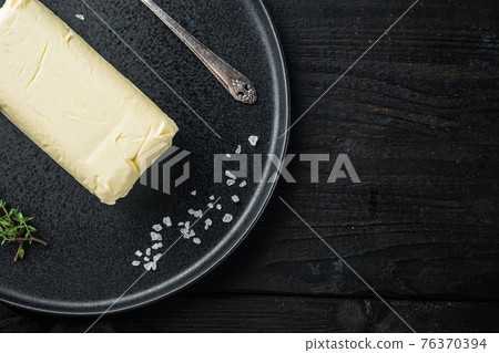 Natural organic butter for breakfast, on black wooden table background, top view flat lay with copy space for text Natural organic butter for breakfast, on black wooden table background, top view flat lay with copy space for text 76370394
