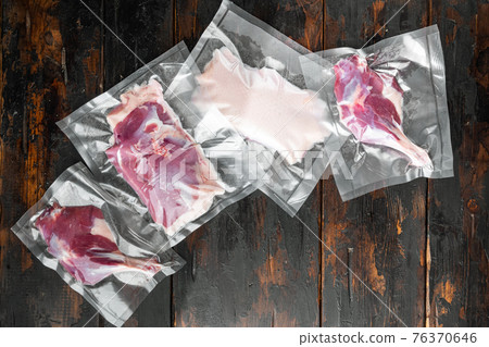 Duck meat vacuum packed, on old dark wooden table background, with copyspace and space for text Duck meat vacuum packed, on old dark wooden table background, with copyspace and space for text 76370646