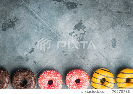Glazed donuts, on gray background, top view flat lay with copy space for text 76370788
