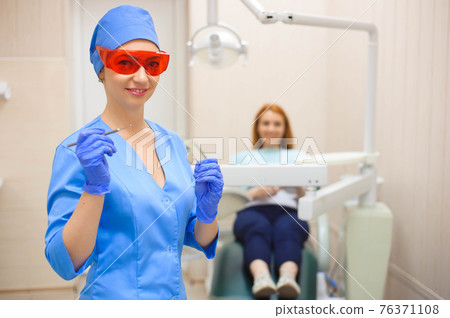 Young woman having medical checkup in the dentist office by the doctor. 76371108