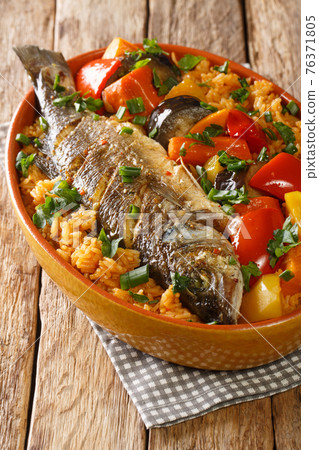 Thieboudienne Fish and Rice The National food of Senegal closeup in the dish. Vertical Thieboudienne Fish and Rice The National food of Senegal closeup in the dish. Vertical 76371805
