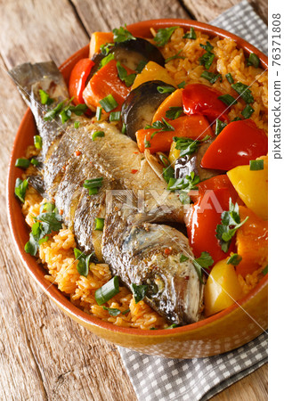 Thieboudienne Ceebu Jen Poisson au Riz a delicious one-pot meal with rice, fish stew and a variety of vegetables that is popular in Senegal closeup. Vertical Thieboudienne Ceebu Jen Poisson au Riz a delicious one-pot meal with rice, fish stew and a variety of vegetables that is popular in Senegal closeup. Vertical 76371808