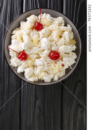 Glorified rice is a dessert salad popular in the Midwestern cuisine served in Minnesota and other states close-up in a plate. Vertical top view Glorified rice is a dessert salad popular in the Midwestern cuisine served in Minnesota and other states close-up in a plate. Vertical top view 76371842