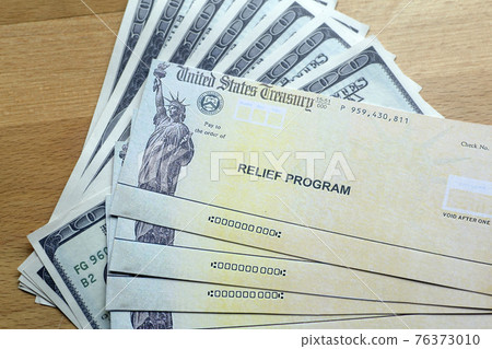 USA dollars background. American rescue plan, USA relief program, stimulus check and Act of 2021 concept. Money, business, profit and livelihood idea 76373010