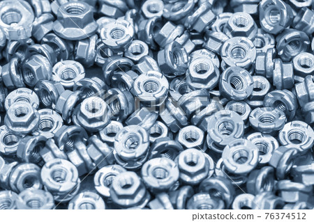 The pile of special industrial nuts . 76374512