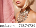 beauty portrait of a young beautiful blonde girl of Asian or Egyptian appearance on a pink solid background. 76374729