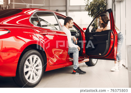 Stylish and elegant family in a car salon Stylish and elegant family in a car salon 76375803