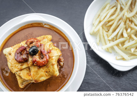 francesinha traditional meat cheese spicy sauce grilled sandwich porto portugal 76376542