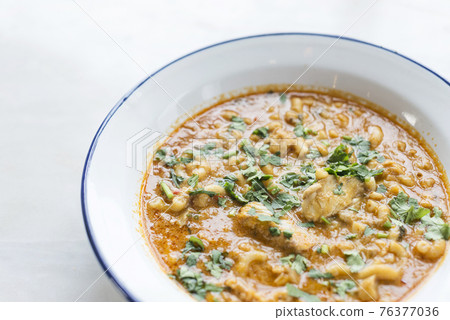 creamy spicy seafood fish soup with coriander creamy spicy seafood fish soup with coriander 76377036