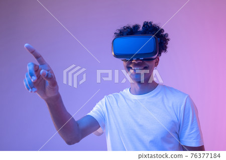 African american young guy in vr glasses enjoying the game African american young guy in vr glasses enjoying the game 76377184