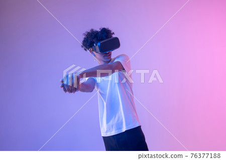African american young guy in vr glasses enjoying the game African american young guy in vr glasses enjoying the game 76377188